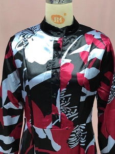 Detailed close-up of floral satin fabric with buttons on long-sleeve dress