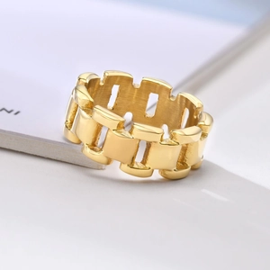 Close-up of golden hollow chain link ring with vintage aesthetic and gear style detail