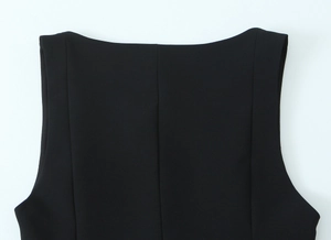 Detailed close-up of a black sleeveless top showing the curved hem and high-quality stitching