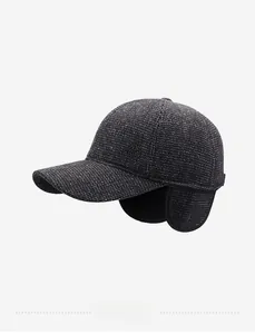 Close-up of wool baseball cap featuring ear flaps and textured fabric with metal logo