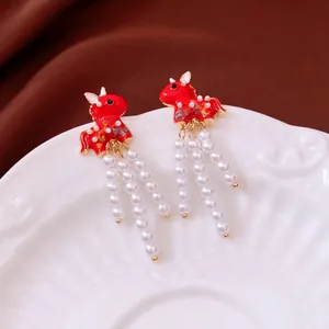 Red horse-shaped pearl tassel earrings in neo-Chinese style on an elegant silk background