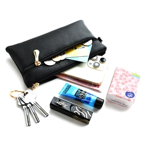Minimalist black leather crossbody bag with dual gold zippers and high capacity storage