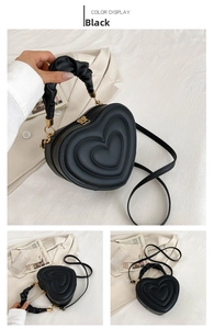 Detail of heart-shaped handbag featuring quilted patterns and a ruffled top handle