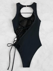 Detail of black one-piece swimsuit featuring hollow-out back design and crisscross straps