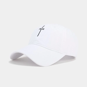 Close-up of white cotton baseball cap with black PEACE embroidery and vertical line detail
