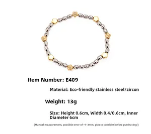 Detail of beaded stretch bracelet with stainless steel beads and zircon floral charms