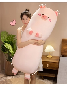 Extra long pink pig plush pillow held by model in a cozy bedroom setting
