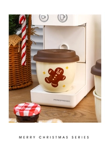 Detailed view of Christmas gingerbread man ceramic mug with brown silicone lid under coffee machine