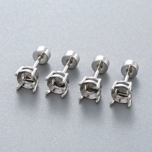 Four silver titanium steel four-claw ear stud bases with screw backs on grey background