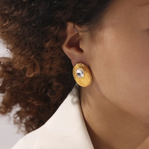 18K gold plated oval earrings with bird nest texture and round crystal on a model