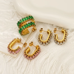 Three pairs of geometric gold earrings with green pink and white zircon crystals
