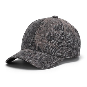Close-up of sparkling sequins and rhinestone texture on a dark grey baseball cap