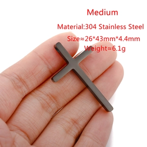 Macro view of matte black stainless steel cross pendant with size and weight specs