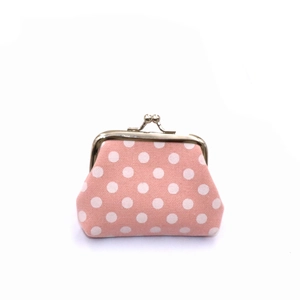 Detailed view of pink polka dot canvas coin purse with vintage metal clasp closure