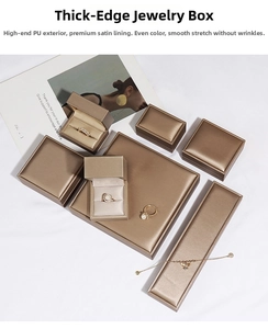 Detail view of champagne gold PU leather jewelry box set with smooth satin interior lining