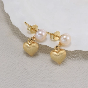 Elegant S925 sterling silver heart earrings with soft pink pearls on matte gold finish