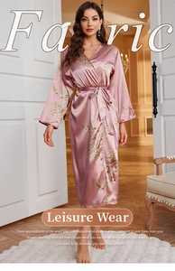 Detail of mauve floral satin robe featuring a tied waist and smooth silk-like texture
