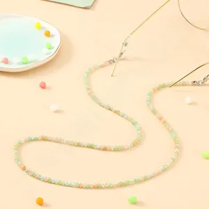 Detail of colorful beaded eyewear strap with silver lobster clasp on glasses