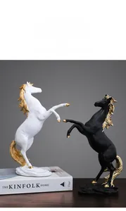 Detailed close-up of modern horse statues with gold accents in black and white finish