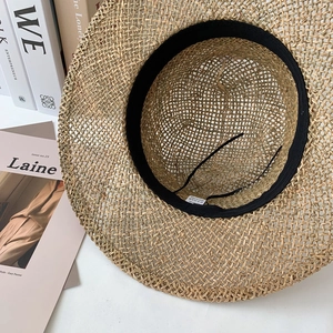 Handmade woven seagrass sun hat in beige with interior sweatband and adjustable strap