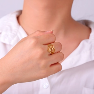 Close-up of golden MOMMY heart open ring with hollow design on female hand