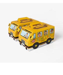 Macro shot of two school bus shaped folding gift boxes with handles on white background