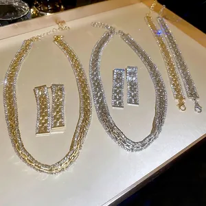 Luxurious geometric crystal necklace set with earrings and bracelets in gold and silver