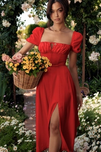 Detail view of red puff sleeve dress with tie-up neckline and front split floral design