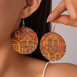 Detail of round cork earrings with architectural print worn by model for size comparison