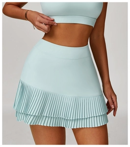 Detail of light blue high-waisted pleated tennis skirt with double-layer hem for sports