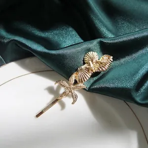 Golden starfish and seashell hair clip with pearls for ocean style hairstyling