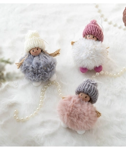 Detailed trio of plush angel ornaments in pink white and grey on soft faux fur