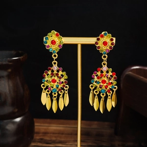 Bohemian colorful rhinestone drop earrings with long metallic leaf tassels on a gold stand