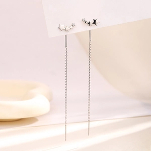 Macro detail of S925 sterling silver stamp on shimmering star tassel earrings