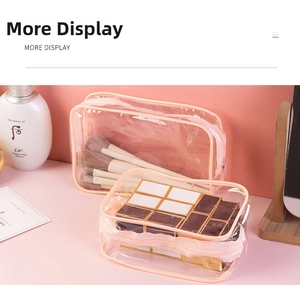Detail of pink transparent PVC toiletry bags showing makeup brush and lipstick storage