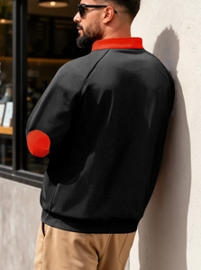 Detailed back view of men's black zip sweatshirt with red stand collar and elbow patches