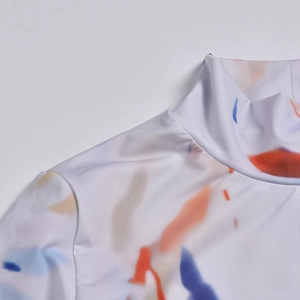 Detail of mock neck and shoulder seams with vibrant abstract watercolor print