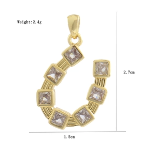 Golden horseshoe pendant with clear square gemstones and detailed size measurements