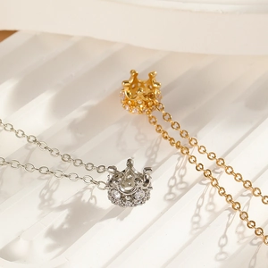 Detailed view of luxury gold and silver crown necklaces with sparkling zircon stones