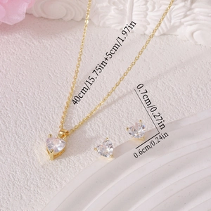 Gold heart jewelry set with necklace and studs shown with detailed size measurements