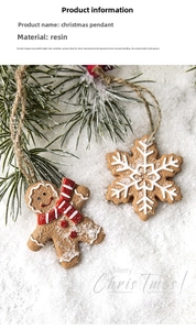 Close-up of resin gingerbread man and snowflake ornaments on artificial snow background