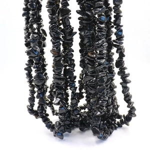 Macro view of natural black crushed stone beads for DIY jewelry and bracelets making