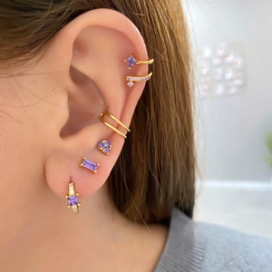 Detailed view of s925 silver needle gold earrings set with purple zircon gemstones