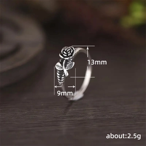 Vintage silver 3D rose ring with antique finish on a rustic wooden background
