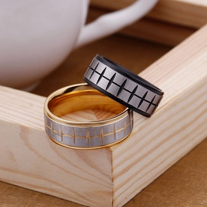 Close-up of tire tread pattern stainless steel rings in black and gold finishes