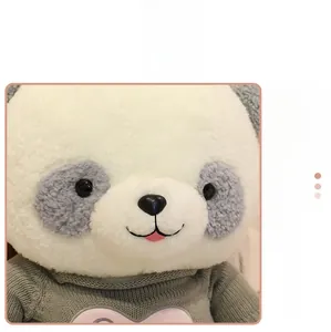Close-up of plush panda toy featuring green knit sweater and soft curly faux fur texture