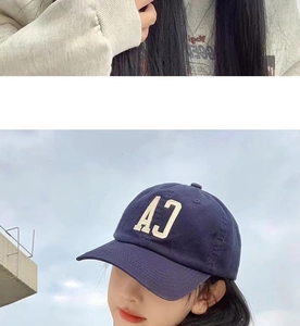 Close-up of navy blue cotton baseball cap featuring white AJ letter embroidery detail
