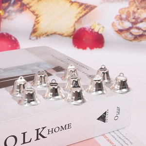 Close-up of ten small silver metal bells with hanging loops for Christmas DIY projects