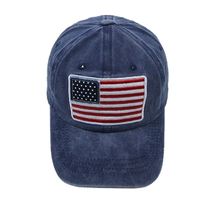 Detailed close-up of American flag embroidery on vintage washed blue cotton baseball cap