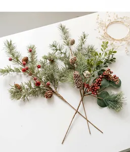 Close-up of Christmas pine picks with natural pine cones, red berries and gold bells